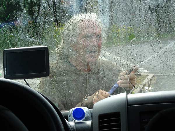 ted falconi cleaning the windshield at a fuel stop near tebay, england on august 3, 2019