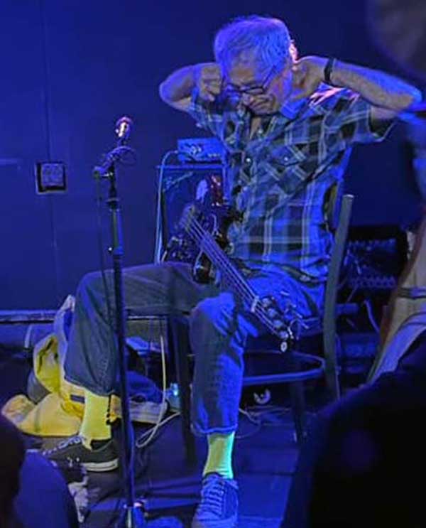 adam schere's photo of mike watt cleaning his ears out before mssv gig at 'boggs social & supply' in atlanta, ga on october 26, 2023