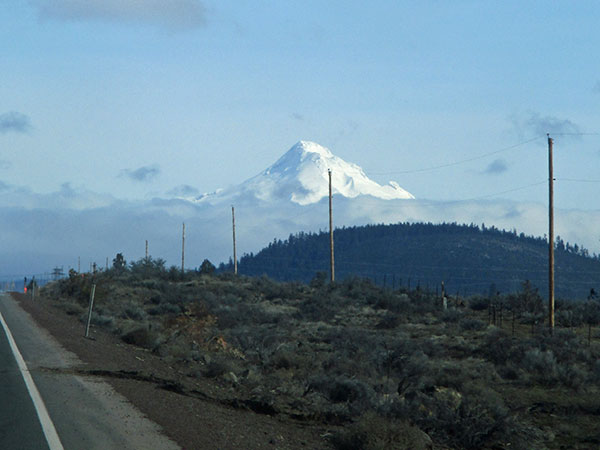 mt hood in the starboard rear mirror while driving in warm springs indian reservation, wora on march 1, 2017