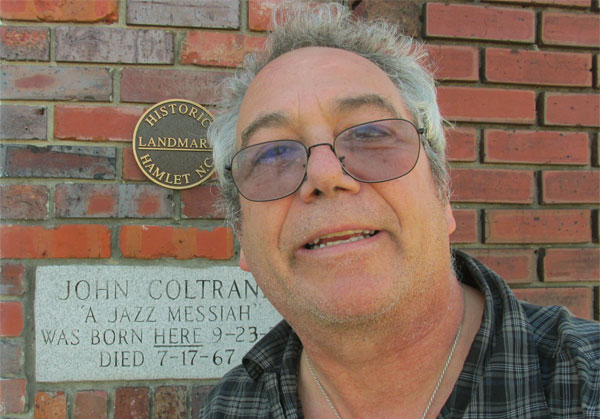mike watt in front of john coltrane's birthplace in hamlet, nc on october 22, 2014