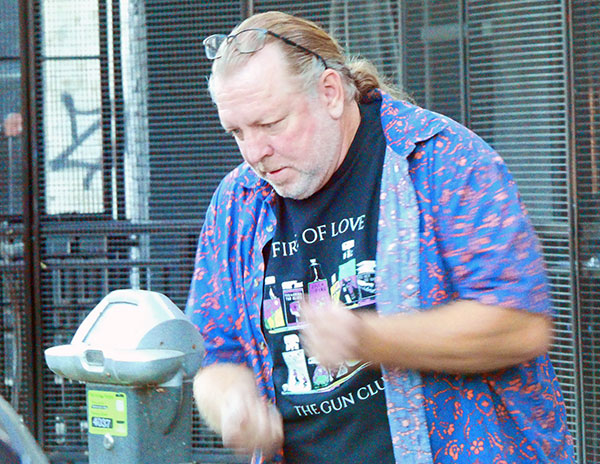 brian mckenna feeding a parking meter in front of 'the torch club' in sacramento, ca on oct 29, 2024