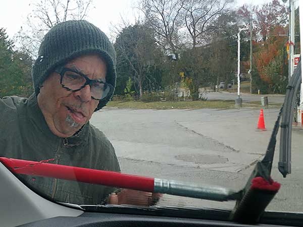 stephen hodges using squeegee on new boat at gas station in new hope, ont, canada on october 9, 2023