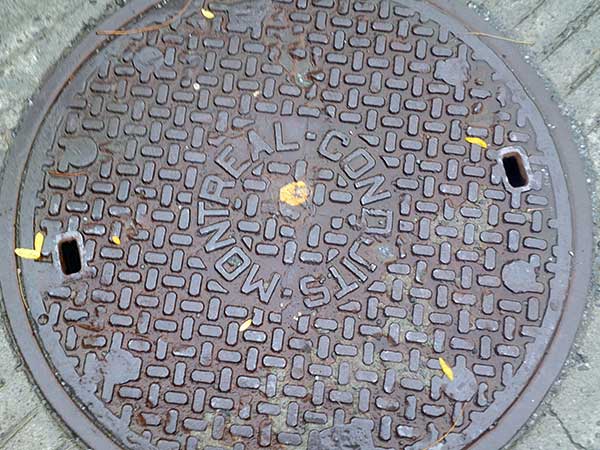 manhole cover near 'little italy' part of montreal, qc, canada on october 9, 2023