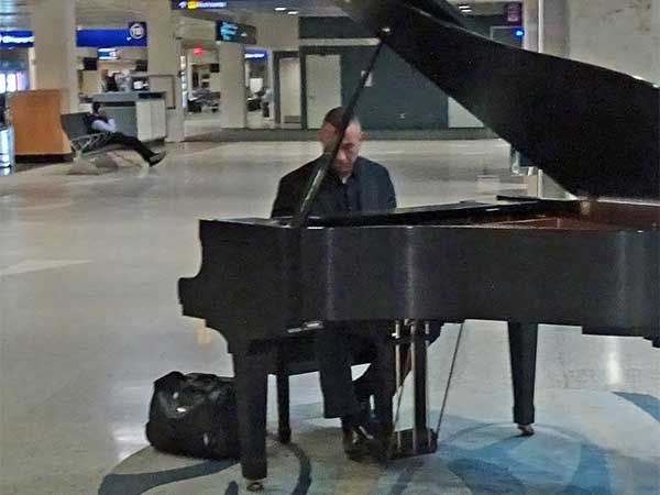 piano player in the baggage area of the minneapolis airport on march 25, 2019