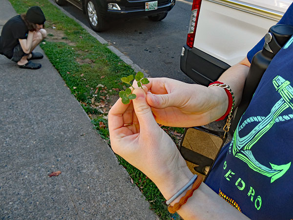 aiden looking for and lily rose finding four-leaf clovers by the boat in front of 'strum pdx' in portland, or on october 2, 2026