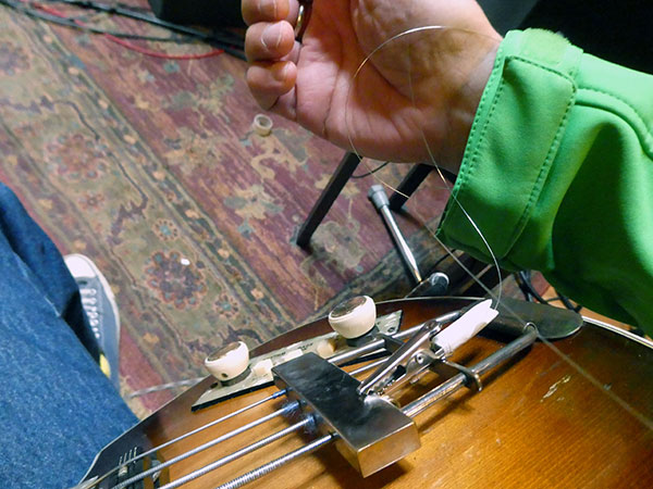 aligator clip on beatle bass bridge w/guitar string wrapped around watt's watch strap to eliminate hum at 'flora' in portland, or on october 4, 2026